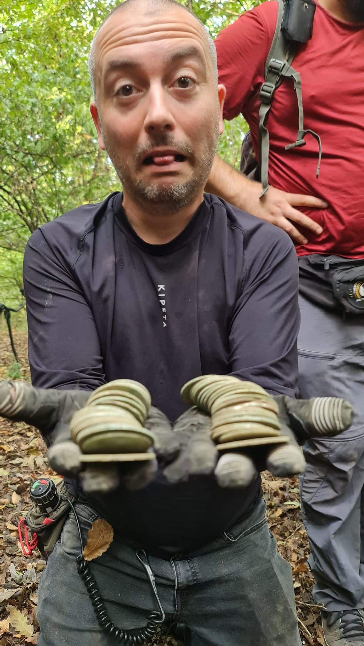 happy detectorist holding the coins